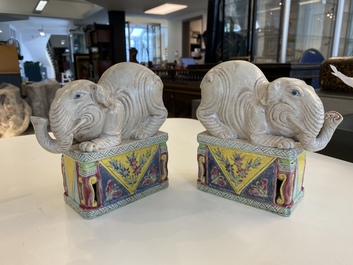 A pair of Chinese famille rose elephants on stands, 20th C.