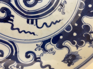 A Chinese blue and white 'dragon' dish and three iron-red and famille rose plates, 18th C.