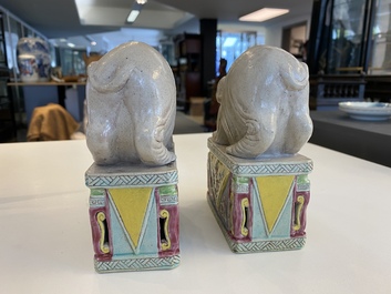 A pair of Chinese famille rose elephants on stands, 20th C.