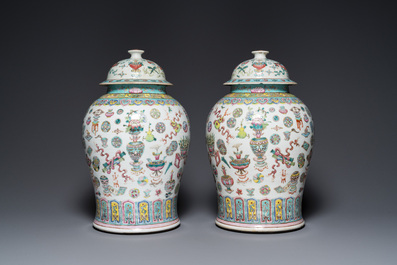 A pair of Chinese famille rose 'antiquities' vases and covers, 19th C.