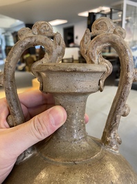 A Chinese straw-glazed stoneware amphora with dragon handles, Tang