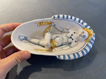 A polychrome French faience oval basin with a bathing woman, Nevers, 17th C.