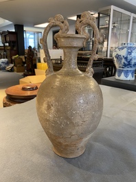 A Chinese straw-glazed stoneware amphora with dragon handles, Tang