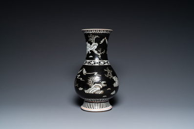 A Chinese famille noire vase with grisaille and iron-red design, 19th C.