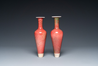 A pair of Chinese peachbloom-glazed vases on wooden stands, Kangxi mark, 19th C.