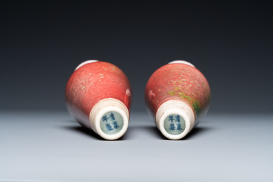 A pair of Chinese peachbloom-glazed vases on wooden stands, Kangxi mark, 19th C.