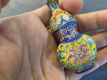 A Chinese Canton enamel snuff bottle and a pair of bone snuff bottles, 19th C.