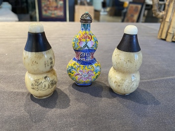 A Chinese Canton enamel snuff bottle and a pair of bone snuff bottles, 19th C.