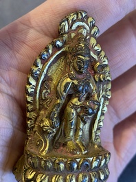A lacquered gilt bronze miniature Buddha, Tibet or Nepal, 15/16th C.