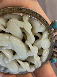 A Chinese reticulated jade 'three peacocks' carving in silver pendant, Qing