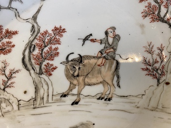 A pair of Chinese iron-red and grisaille 'boy on buffalo' plates, Qianlong