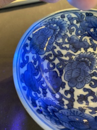 A pair of Chinese blue and white 'lotus scroll' stem cups, Kangxi