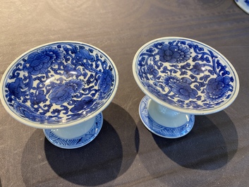 A pair of Chinese blue and white 'lotus scroll' stem cups, Kangxi