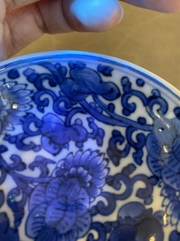 A pair of Chinese blue and white 'lotus scroll' stem cups, Kangxi