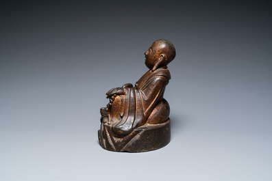 A Chinese gilt bronze figure of Buddha seated on a rock, Ming