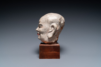 A Chinese painted stucco head of a Luohan, probably Jin or Yuan, 12/14th C.