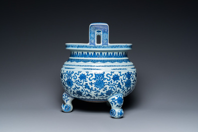 A large Chinese blue and white 'bajixiang' tripod censer with lotus scrolls, Qianlong