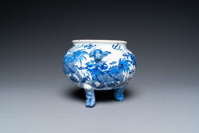 A Chinese blue and white 'mythical beasts' tripod censer, 19th C.