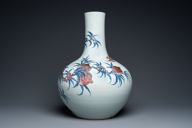 A Chinese blue, white and copper-red 'nine peaches' bottle vase, Guangxu mark and of the period