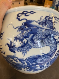 A Chinese blue and white 'dragons and carps' jardini&egrave;re on wooden stand, 19/20th C.