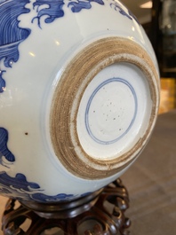 A Chinese blue and white 'dragons and carps' jardini&egrave;re on wooden stand, 19/20th C.