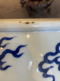 A Chinese blue and white 'dragons and carps' jardini&egrave;re on wooden stand, 19/20th C.