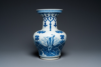 A Chinese blue and white vase with rocks in a wavy sea, Qianlong/Jiaqing