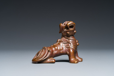 A Chinese bronze 'Buddhist lion' scroll weight, Qing