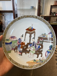 A fine Chinese famille rose eggshell porcelain plate with a boy and two governesses in an interior, Yongzheng