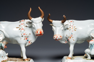 A pair of cold-painted white Dutch Delft cow milkers' groups, 18th C.