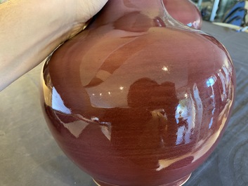 A pair of Chinese monochrome peachbloom-glazed bottle vases, 19th C.