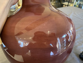 A pair of Chinese monochrome peachbloom-glazed bottle vases, 19th C.