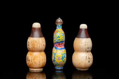 A Chinese Canton enamel snuff bottle and a pair of bone snuff bottles, 19th C.