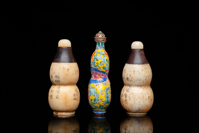 A Chinese Canton enamel snuff bottle and a pair of bone snuff bottles, 19th C.