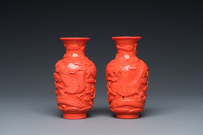 A pair of rare Chinese 'Beijing glass' vases imitating coral on wooden stands, 19/20th C.