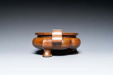 A Chinese lotus-shaped bronze tripod censer, late Ming or early Qing