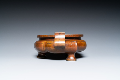 A Chinese lotus-shaped bronze tripod censer, late Ming or early Qing