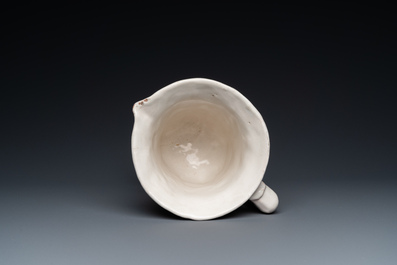 A white Dutch Delft gadrooned dish and an unusual French Nevers helmet-shaped ewer, late 17th C.