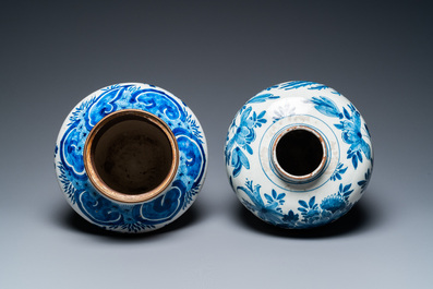 Two Dutch Delft blue and white vases with birds near blossoming branches, 18th C.