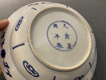 A pair of Chinese blue and white 'Mu Guiying' plates, Kangxi mark and of the period