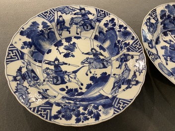 A pair of Chinese blue and white 'Mu Guiying' plates, Kangxi mark and of the period