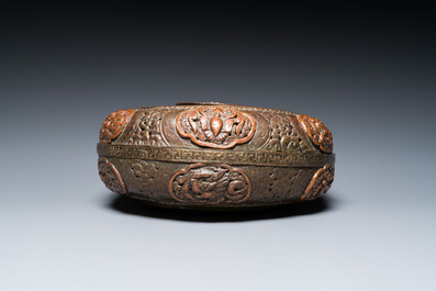 A Tibetan pierced and repouss&eacute; copper scent box and cover with inscribed mantra, 18/19th C.