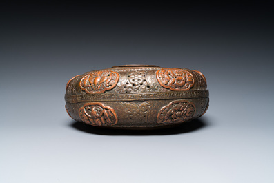 A Tibetan pierced and repouss&eacute; copper scent box and cover with inscribed mantra, 18/19th C.