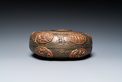 A Tibetan pierced and repouss&eacute; copper scent box and cover with inscribed mantra, 18/19th C.