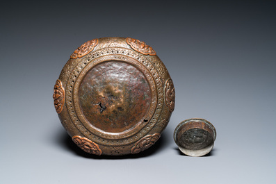 A Tibetan pierced and repouss&eacute; copper scent box and cover with inscribed mantra, 18/19th C.