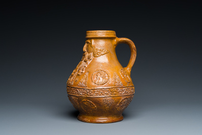 A rare German stoneware bellarmine jug with a bearded face sticking his tongue out, Cologne, 16th C.