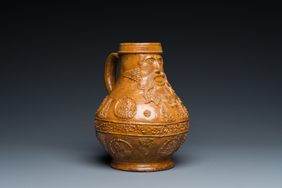 A rare German stoneware bellarmine jug with a bearded face sticking his tongue out, Cologne, 16th C.