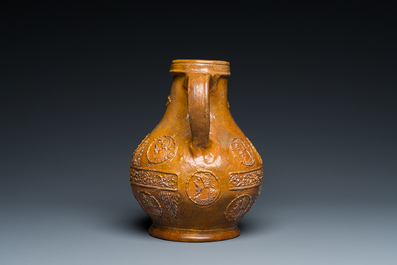 A rare German stoneware bellarmine jug with a bearded face sticking his tongue out, Cologne, 16th C.