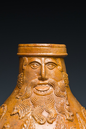 A rare German stoneware bellarmine jug with a bearded face sticking his tongue out, Cologne, 16th C.