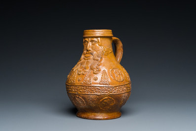 A rare German stoneware bellarmine jug with a bearded face sticking his tongue out, Cologne, 16th C.